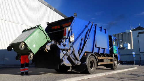 Construction site with builders waste being cleared in Golders Green